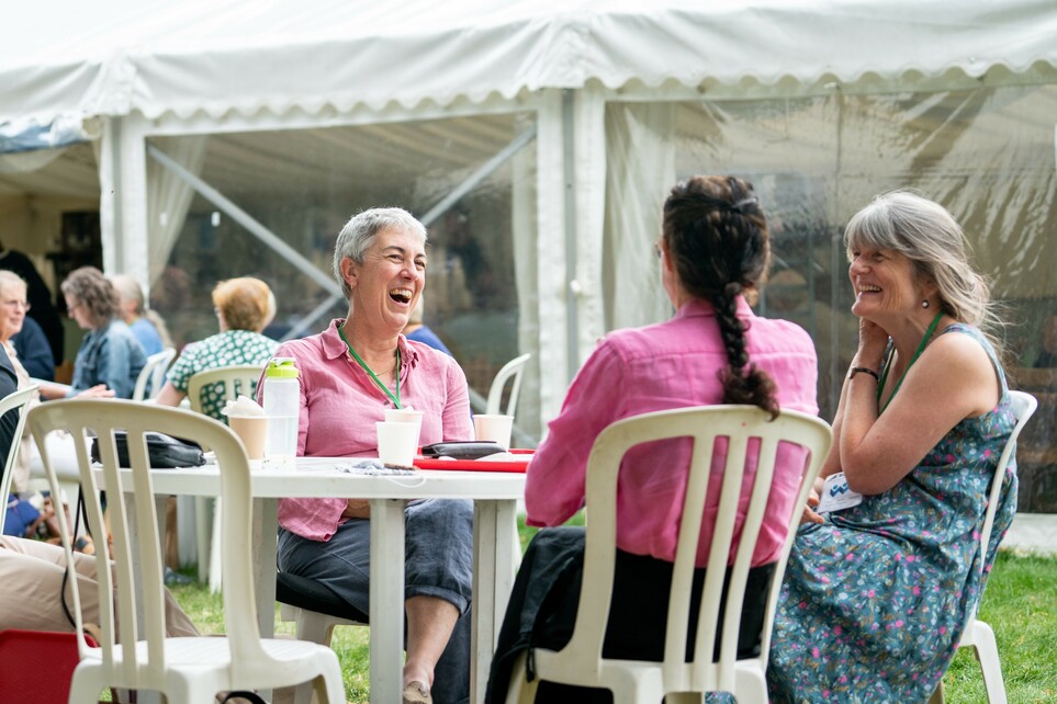 People sat down socialising in the festival village