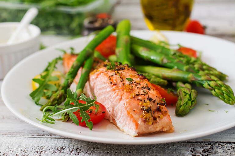 Example of food available, baked salmon garnished with asparagus tomatoes